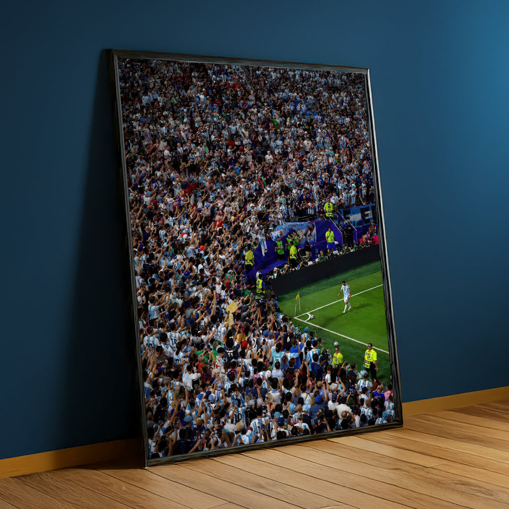 Messi Stadium Legend black framed canvas against a blue wall